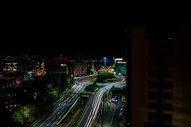 Nighttime aerial view of Pune city with light trails from vehicles on highways, showcasing the vibrant urban landscape where the best content creator for small business can help local enterprises thrive in this competitive market.